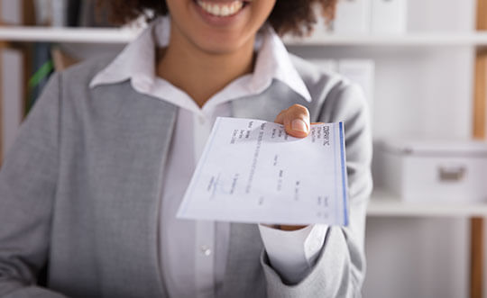 woman holding cheque