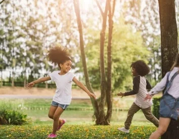 Children Running In Greenspace