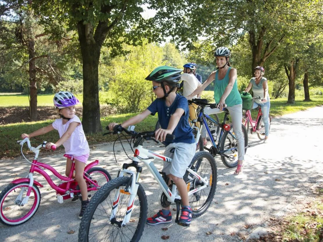 Family biking on community trail