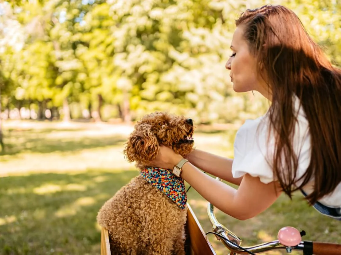 Woman and puppy in park setting