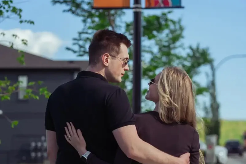 Couple walking arm in arm through a Cardel Homes community.