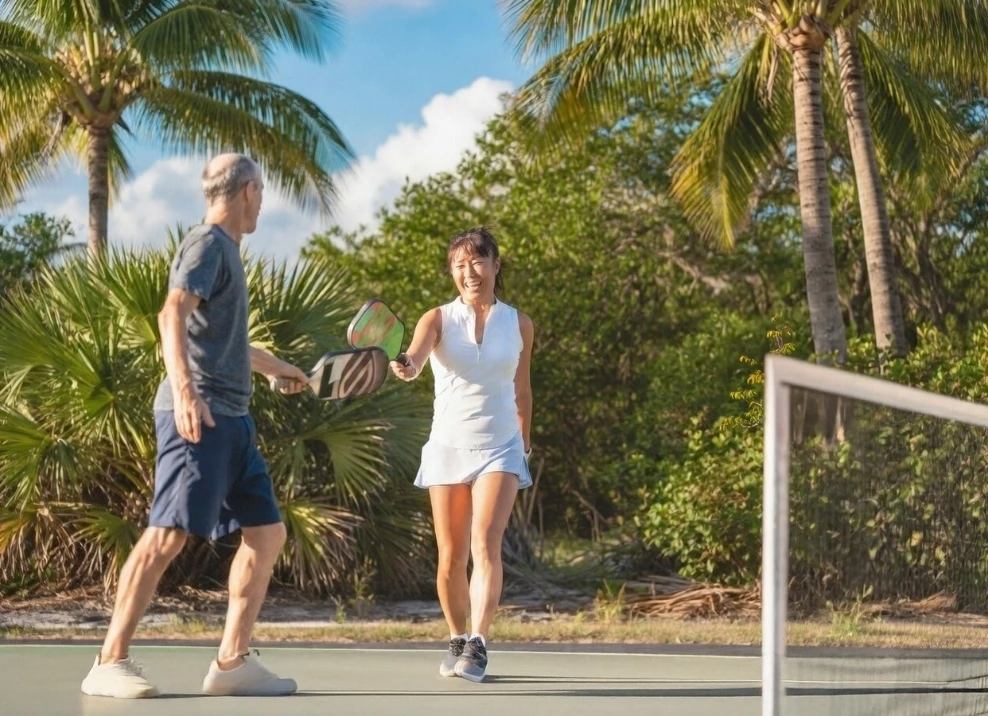 couple playing pickleball outdoors