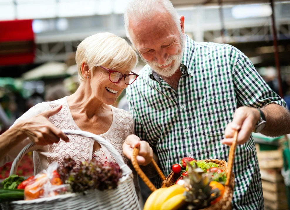 elderly couple shopping produce