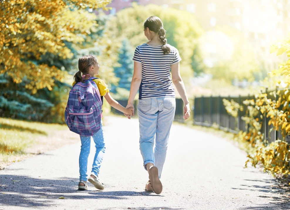 mother daughter walking to school